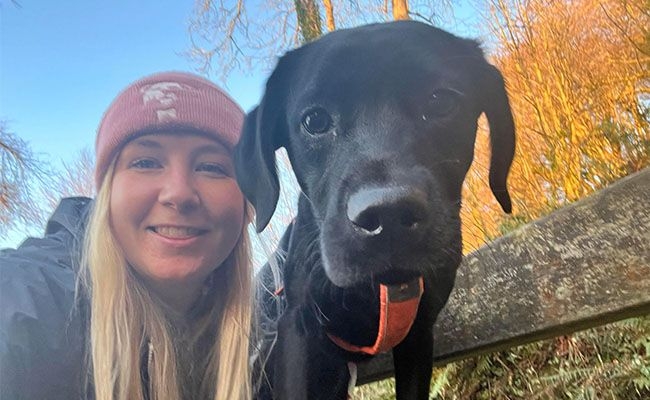 Happy dog next to their human