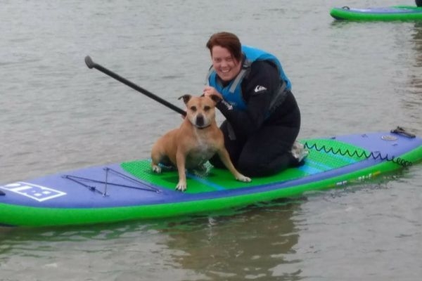 Claire enjoying paddleboarding with doggy Pip 