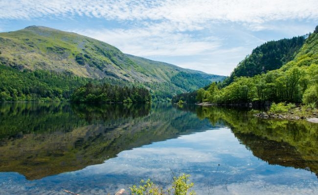 Thirlmere Lake on a very still day, the water looks like glass as it reflects the surrounding hillsides