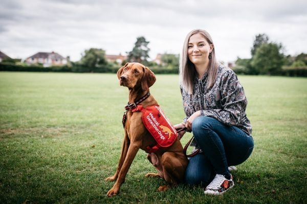 medical detection dog Barna with red jacket