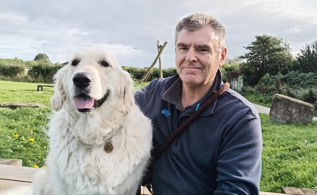 Doggy member, Bobby, and borrower, Uncle Nellie, sat in the park smiling together on a sunny day