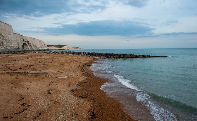 Early morning at Brighton Beach, the beach is empty and the sea is calm 