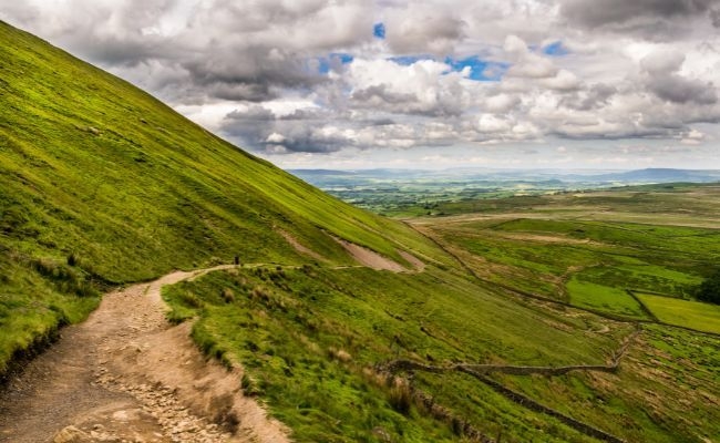 A winding path on Pendle Hill with views of the surrounding countryside