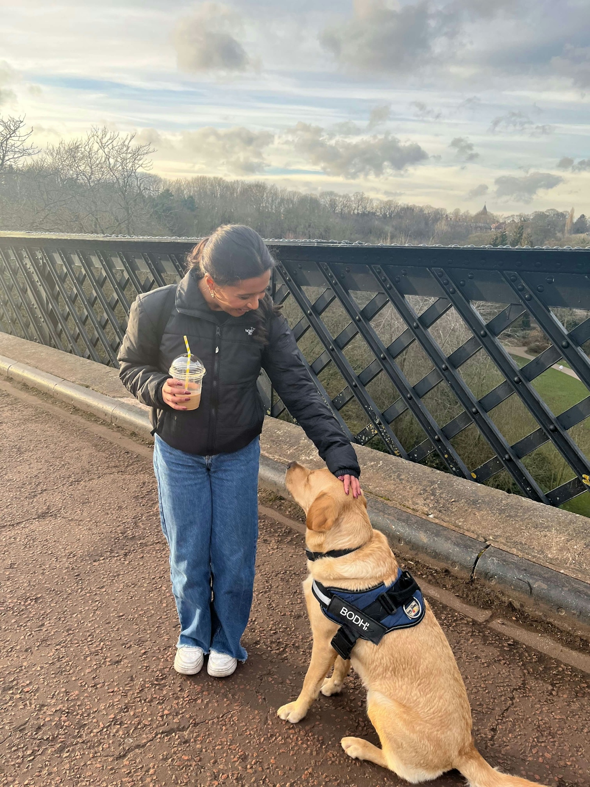 student Hiruni with Bodhi, the Labrador