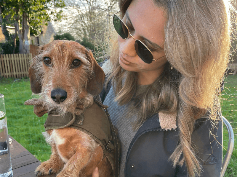 Woman with dog in pub garden