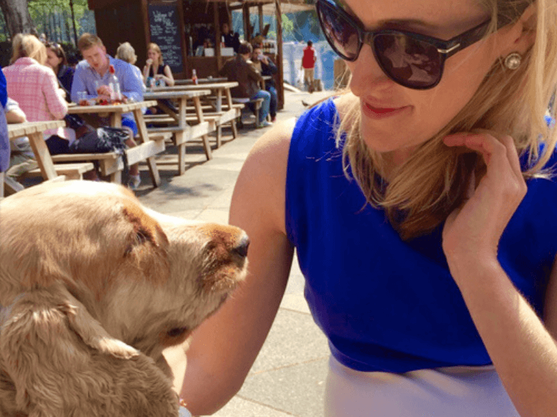 Woman with cute blonde dog at pub