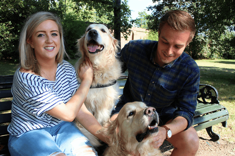 Couple with adorable golden dogs